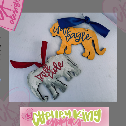 Hand painted and personalized art ornament- Alabama Elephant or Auburn Tiger Approximately 6" ... Just let us know what you would like it to say, the color bow, and the color writing!:)

I design and personalize each of the ornaments to order!&nbsp; If you would like a different color hat or special design, please reach out to me at chelley@chelleyking.com!